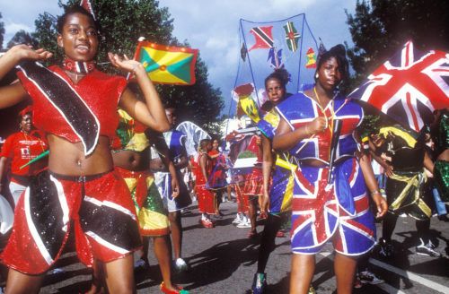 Flag Procession girls in full costume, Notting Hill Carnival, London, 2000s © Giles Moberly